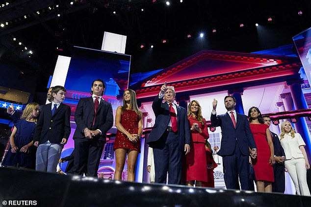 Donald Trump gestures as he is joined on stage by his wife Melania, Republican vice presidential nominee JD Vance and members of his family.