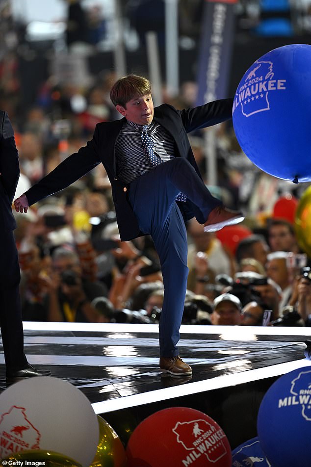 One of Trump's grandsons plays with balloons at the conclusion of the Republican National Convention