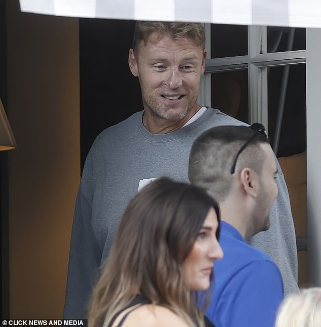 The former cricket captain, 46, was seen smiling and laughing as he chatted to people outside the swanky Charlotte Street Hotel.