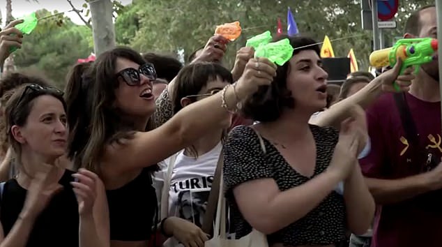 Protesters fired water pistols at tourists eating at popular spots in the city.