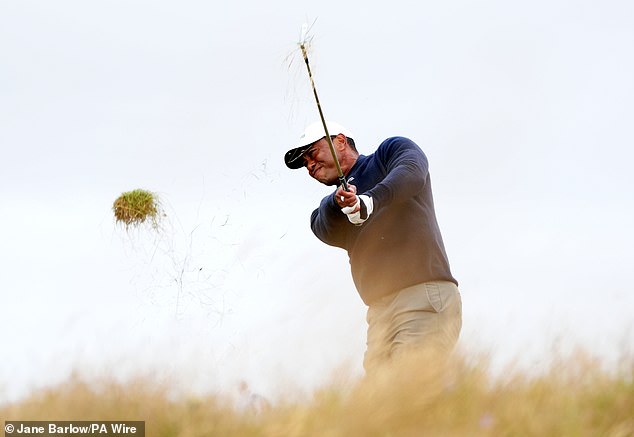 Woods hits a shot from the rough on day two of the Open Championship in Scotland