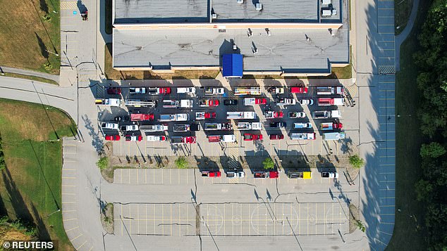 A drone view shows emergency vehicles lined up outside Freeport Area High School, preparing for the procession.