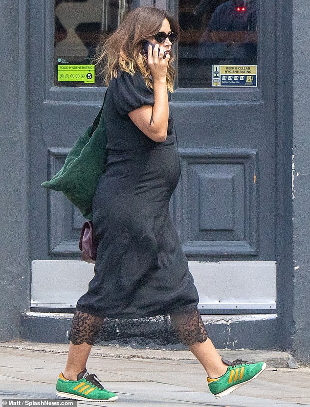 Jenna completed her look with a pair of multi-colored Adidas sneakers and a larger green bag.