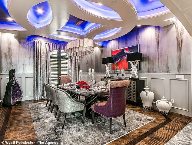 The dining room features a playful geometric ceiling with LED backlighting and marble walls.