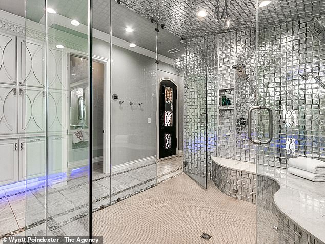 One of the bathrooms features a metallic silver wall and a glass exterior.