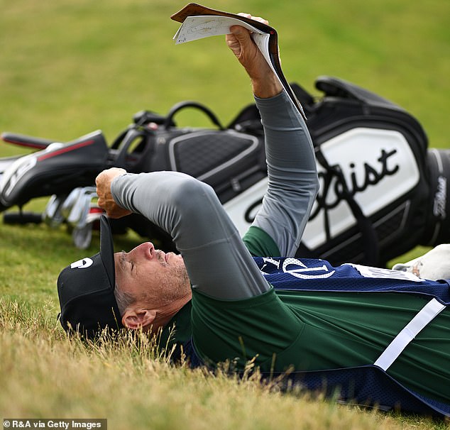 Scott, 39, reviews a map of Royal Troon's 45-hole golf course during the sixth hole on Friday.