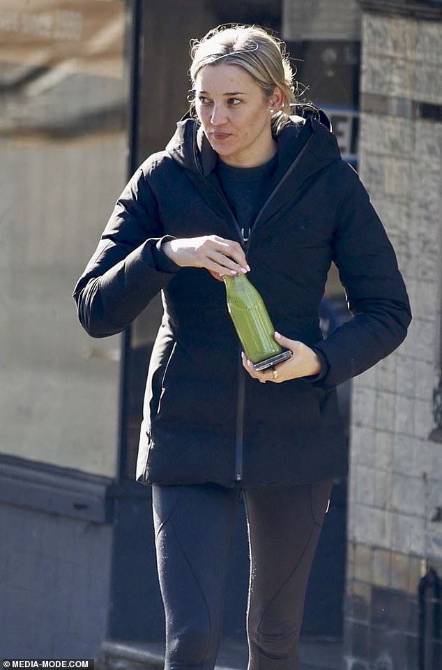 The designer was all smiles during her stroll, holding a healthy green juice in a bottle in her hand.