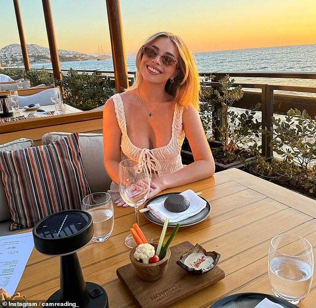 Cam was also all smiles and looked stunning in a white crochet top as the couple enjoyed a romantic dinner on the beach.