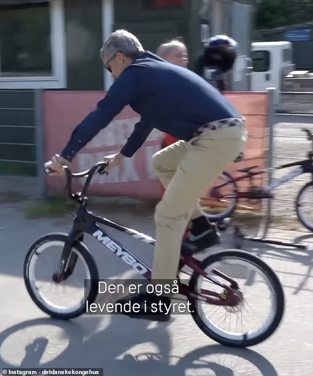 Pictured: King Frederik is seen riding a BMX bike after watching Danish Olympian Malene Kejlstrup train