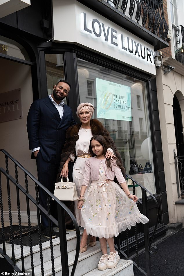 Emily, her husband Adam and Moo (pictured outside their Knightsbridge store) have moved to Dubai.