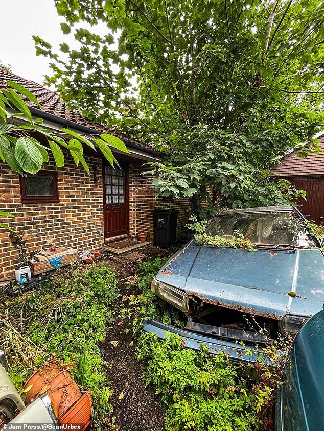 In the video, Sean can be seen wandering outside, showing the camera four abandoned and neglected cars, overgrown and rusting, in the garden.