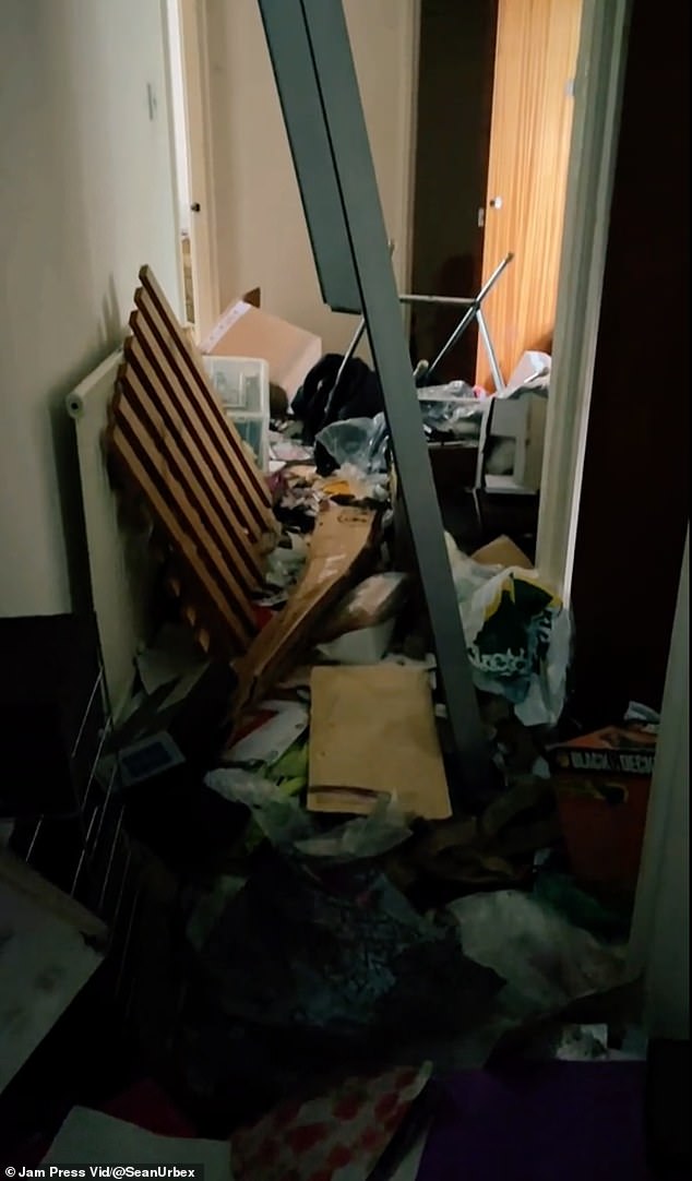 The hallway was blocked by piles of trash, making it impossible to walk through.