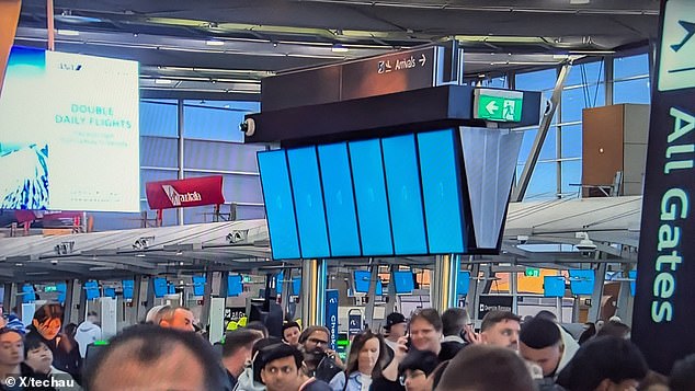 A faulty update from a cybersecurity firm caused Microsoft computers to crash at airports (pictured, locked computers at Sydney airport), banks and other major businesses.