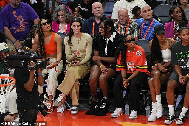 Clark watched from the sidelines alongside teammate Aaliyah Boston and other WNAB players.