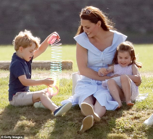 Prince George practices tricks with a rainbow slinky as his mother Kate and sister Charlotte laugh during the Maserati Royal Charity Polo Trophy at the Beaufort Polo Club in 2018