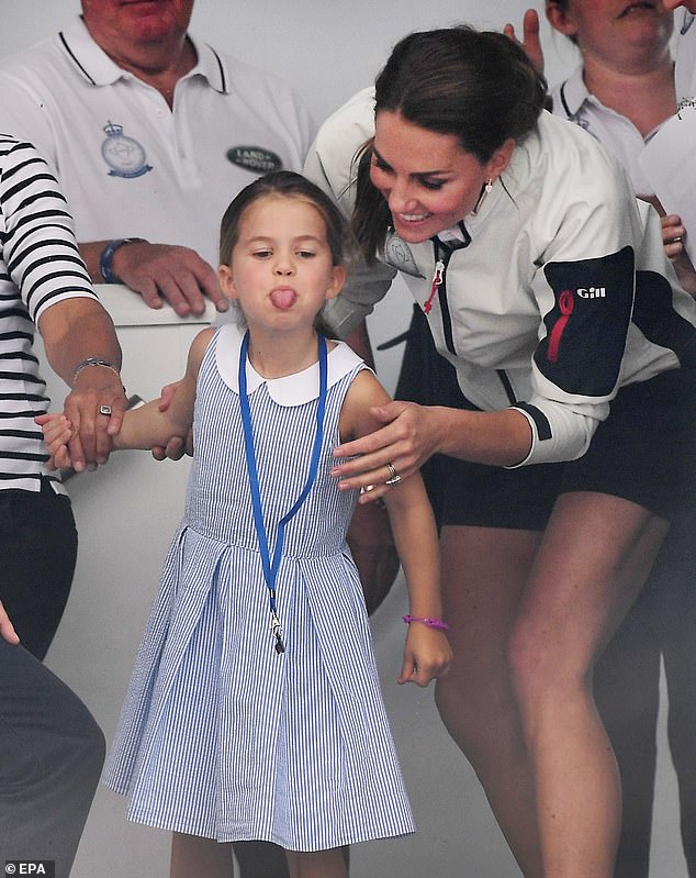 Kate tries to distract her mischievous daughter Charlotte as she sticks her tongue out at the crowd during the King's Cup sailing regatta on the Isle of White in 2019. Kate and William both took part in the race.