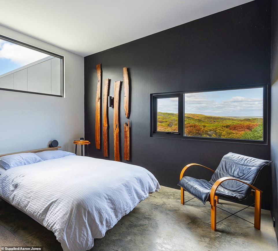 Bedroom windows open to the stark beauty of King Island's coastal landscape.