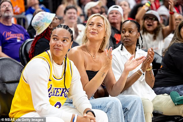 Cunningham watched the game alongside Kristi Tolliver (left) and LA Sparks guard Crystal Dangerfield (right)