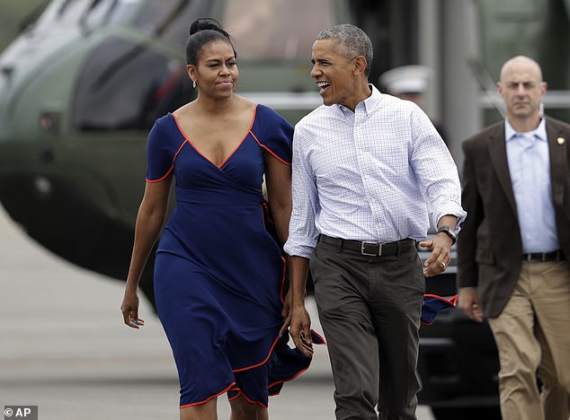 The Obamas are shown walking on the tarmac at Martha's Vineyard Airport in West Tisbury, Massachusetts, in August 2016 for their summer vacation.