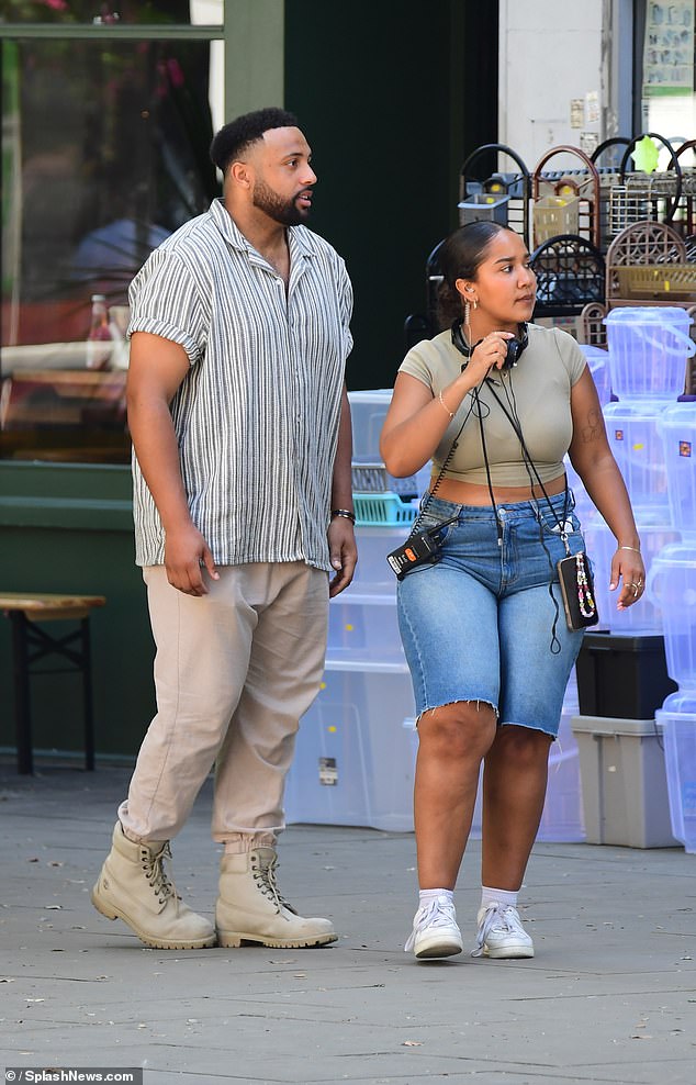 Meanwhile, her date wore an oversized striped shirt with a pair of cargo pants and boots.