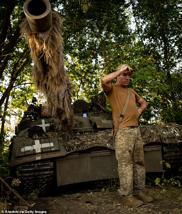 A soldier from the 80th Air Assault Brigade climbs out of a -80 tank during training in Ukraine