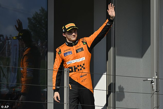 Piastri pictured celebrating his victory by waving to the crowd at the Hungaroring circuit