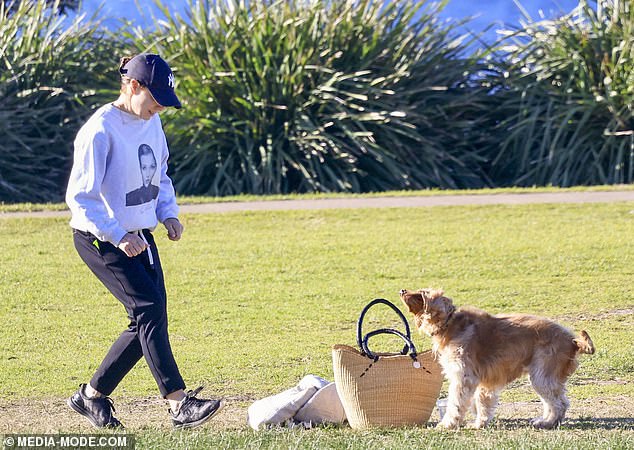 Kate was seen carrying her bag and a picnic blanket before placing the items on the grass as she watched her dog run around.