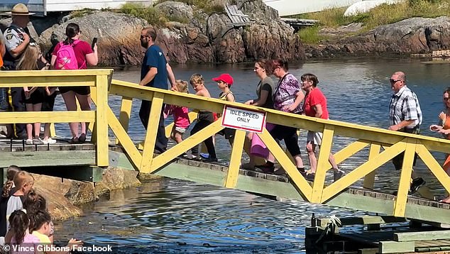 The villagers rush to the dock to welcome the fishermen.