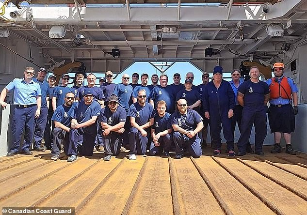 The seven crew members pictured here with their rescuers, the Canadian Coast Guard.