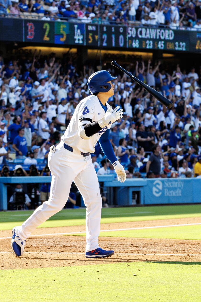 Dodgers star Shohei Ohtani flips his bat after hitting a 473-foot home run at Dodger Stadium.