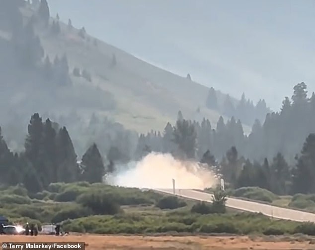 The black Porsche flew down the road lined with lush vegetation and mountain views when it burst into smoke.