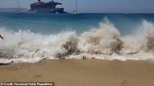 Water crashed onto the beach before covering the sand, knocking some people off their feet.