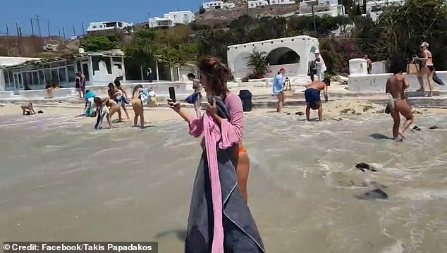 Shocked tourists were seen rushing to collect their belongings before they were swept away by the water.