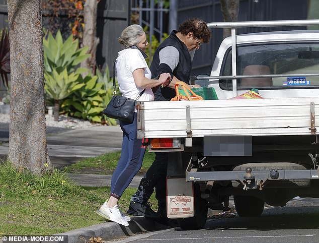 The 57-year-old arrived at the Melbourne address with a truck and was seen unloading items from the back while his partner gave him a hand.