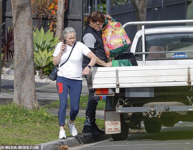 The Australian actor was spotted moving into a new home with the help of a friend on Saturday (pictured)