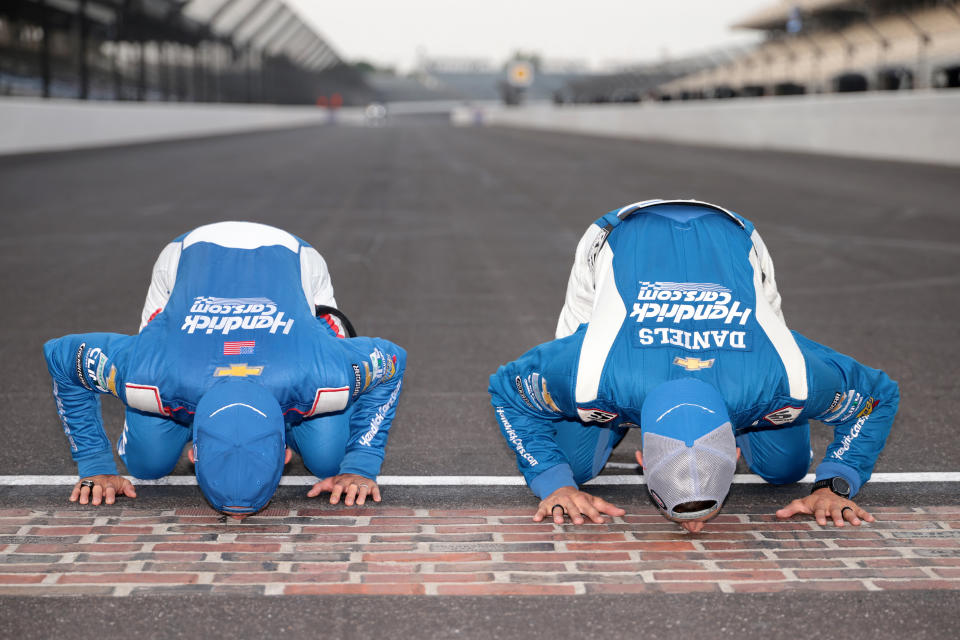 Larson (left) and his crew chief, Cliff Daniels, kiss the brick patio. (James Gilbert/Getty Images)