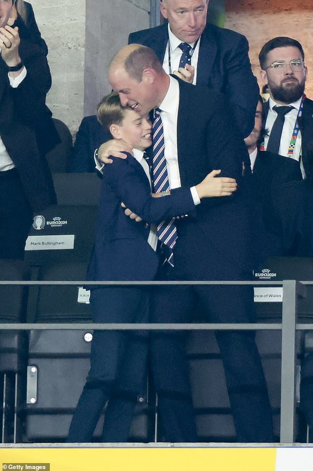 Prince William hugs his eldest son and second in line to the throne, Prince George, during the Euro 2019 final in Berlin