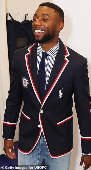 Athletes will wear a navy blue jacket with white and red details.