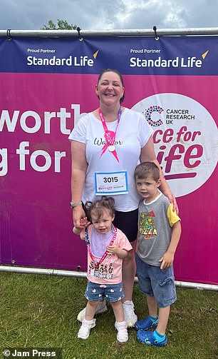 Danielle poses at Cancer Research UK's Race for Life with her children Callum, four, and Sienna-Rose, one.