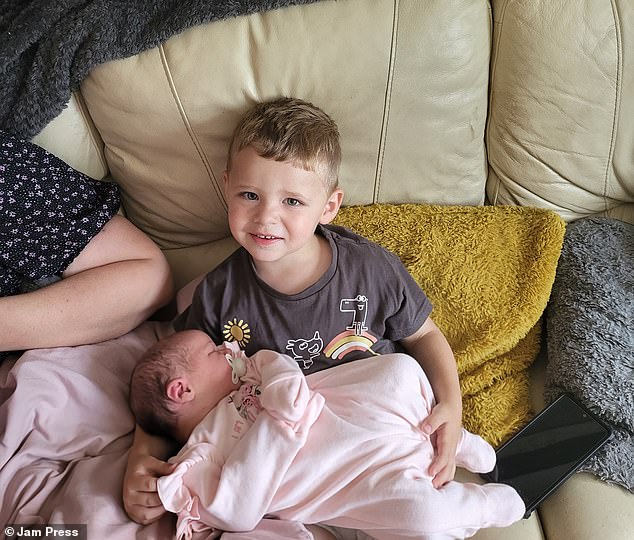 Callum, now a proud big brother, poses with his little sister, Sienna-Rose