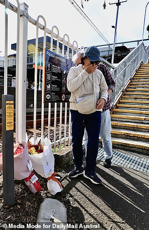 Pictured here, a member of the public lays a wreath at Carlton train station.