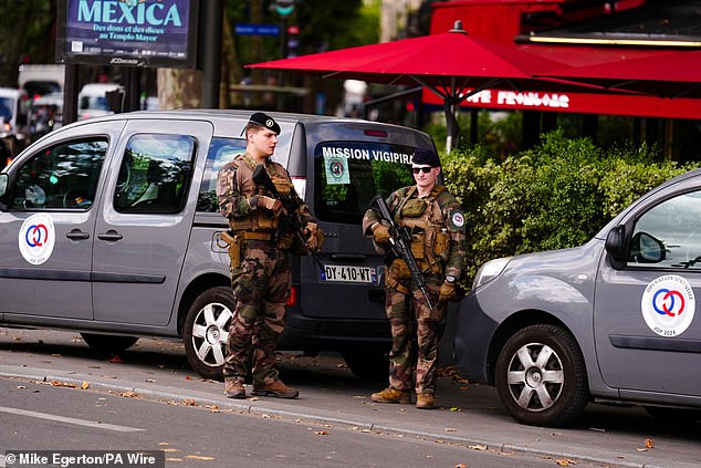 Armed guards near Place de la Bastille, Paris. The opening ceremony of the Paris 2024 Olympic Games will take place on Friday, July 26 along the River Seine.