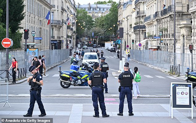 Police officers take security measures as preparations continue ahead of the opening of the Paris 2024 Olympic Games on July 22, 2024 in Paris.