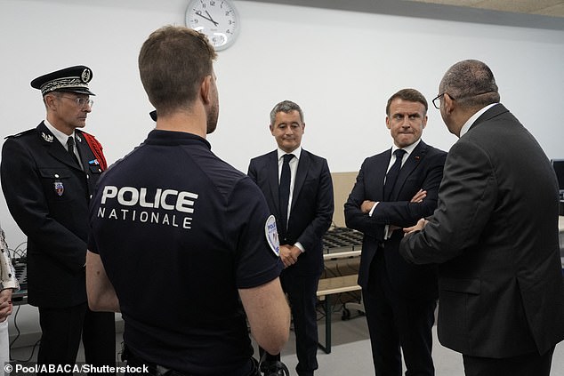 French President Emmanuel Macron (second from right) listens to Paris Police Prefect Laurent Nunez (right) with French Interior Minister Gerald Darmanin as he visits the Olympic Village police station, at the 2024 Summer Olympics, Monday, July 22, 2024