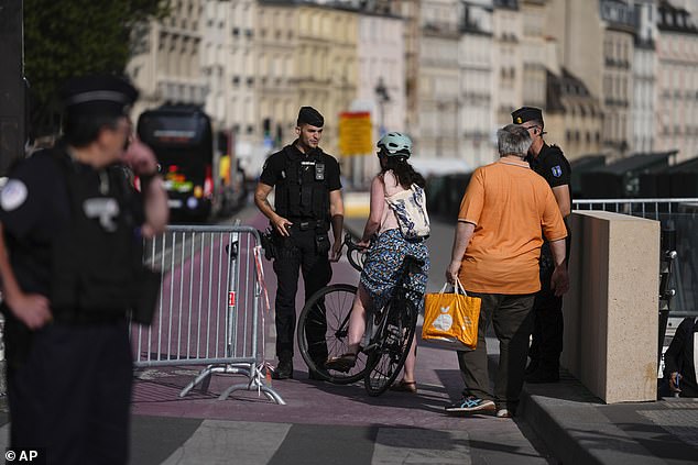 Police control access to roads near the River Seine ahead of the 2024 Summer Olympics