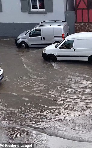 Motorists drive through floodwaters in France