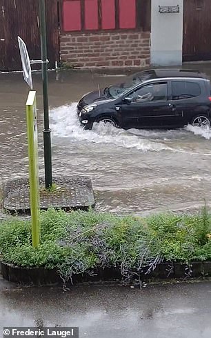 Motorists drive through floodwaters in France