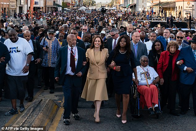 US Vice President Kamala Harris (center) marches across the Edmund Pettus Bridge to commemorate the 57th anniversary of the 