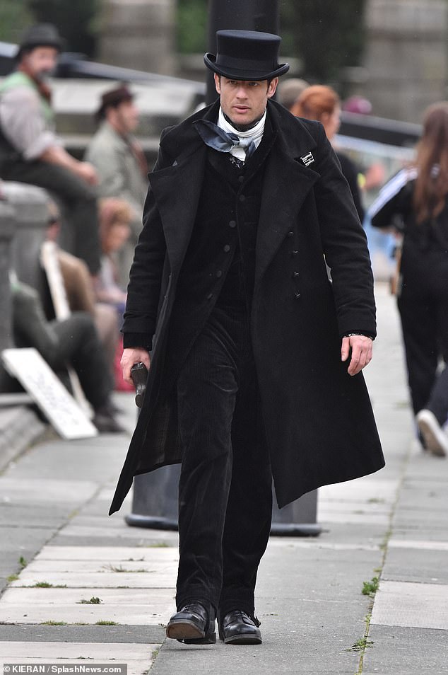 He cut a dapper figure in a black suit which he paired with a white scarf, a long coat and a top hat.