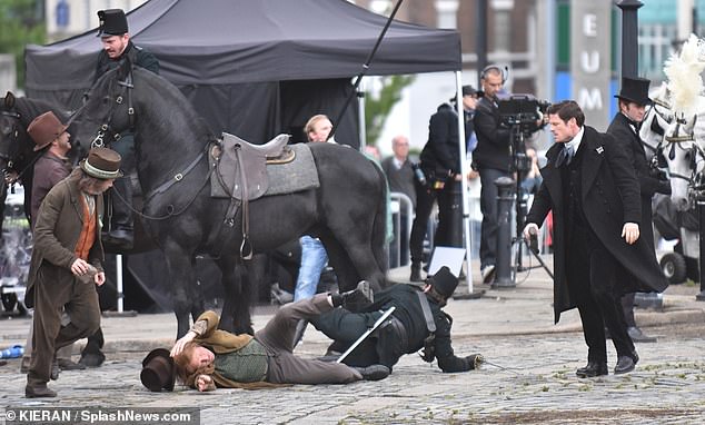 Two men were seen on the ground while James was filming in Liverpool